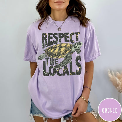 Comfort Colors tee in Orchid featuring vintage style sea turtle graphic with Respect the Locals text