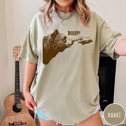 Comfort Colors tee in Khaki featuring a brown ink graphic of a human finger booping a bear nose
