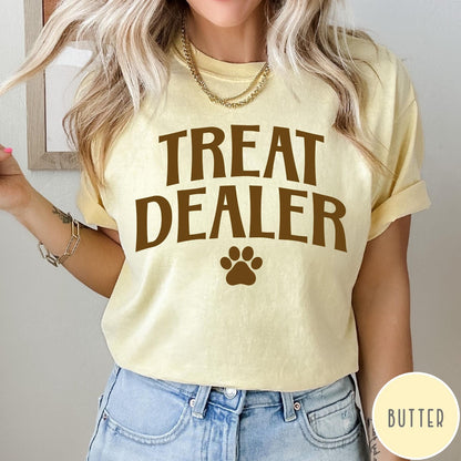 Comfort Colors tee in Butter featuring dog owner design with Treat Dealer text and a paw print