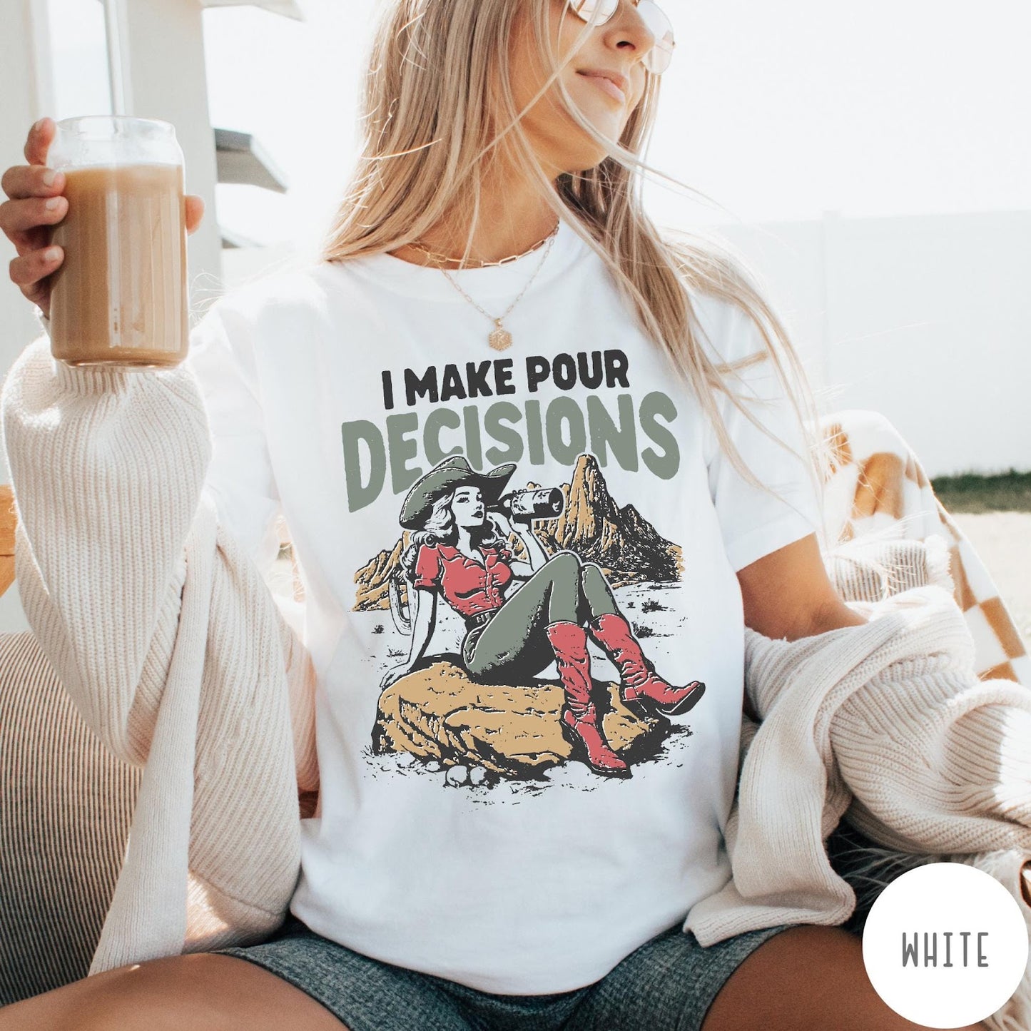 Comfort Colors tee in White featuring western style graphic of a cowgirl sitting on a rock drinking