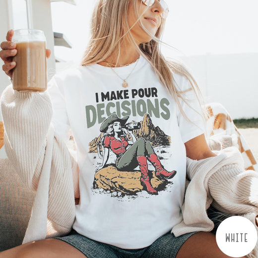 Comfort Colors tee in White featuring western style graphic of a cowgirl sitting on a rock drinking