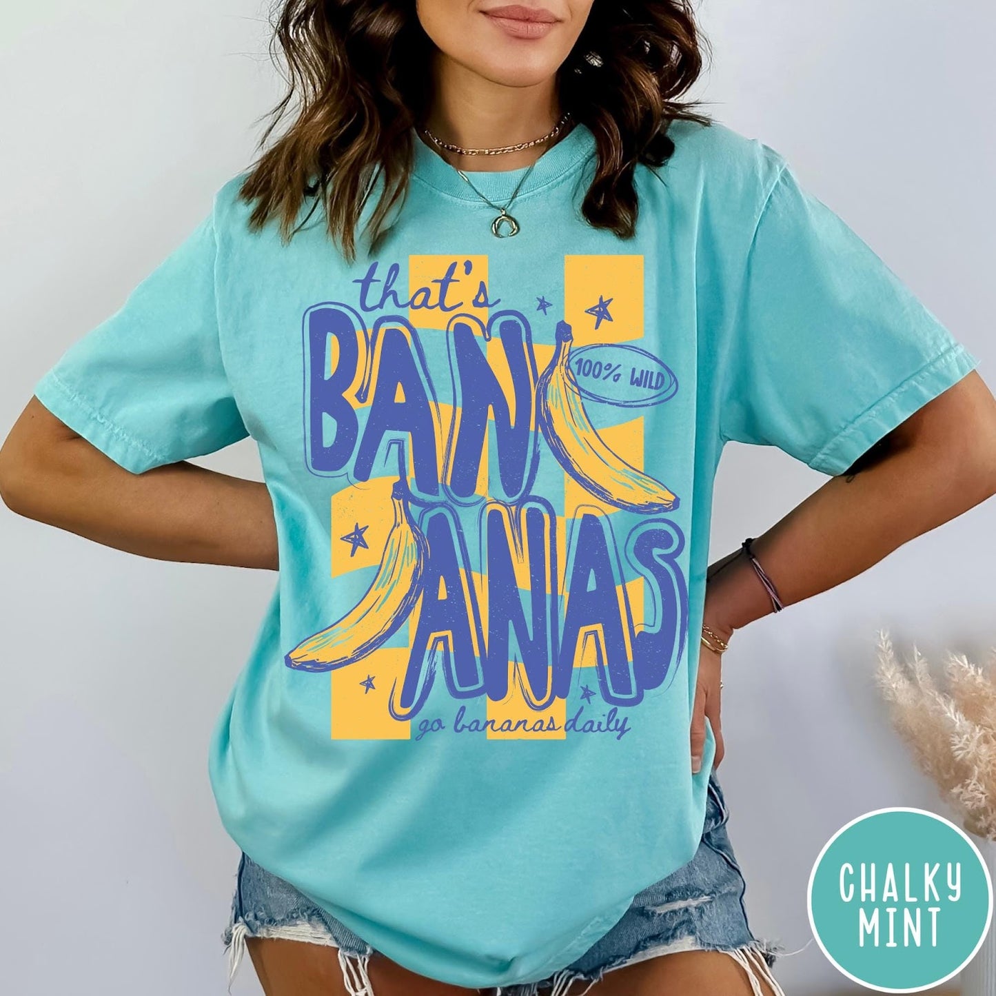 Comfort Colors tee in Chalky Mint featuring retro style banana graphic with text that is bananas go bananas daily