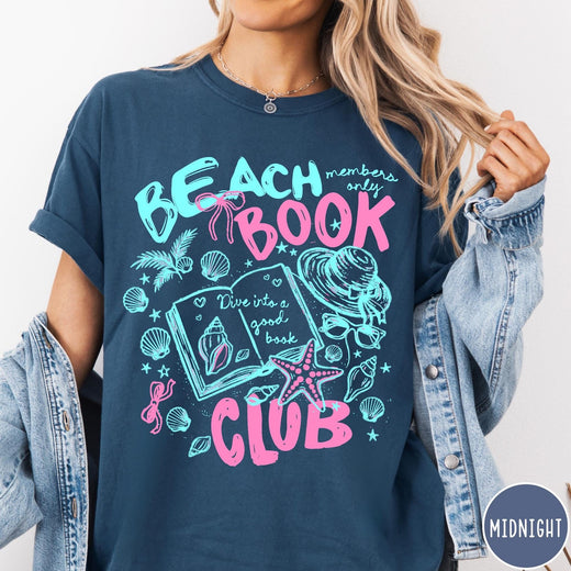 Comfort Colors tee in Midnight featuring beach book club graphic with seashells, starfish, and a sun hat