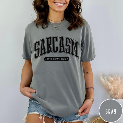 Comfort Colors tee in Gray featuring collegiate style text reading Sarcasm It's How I Hug