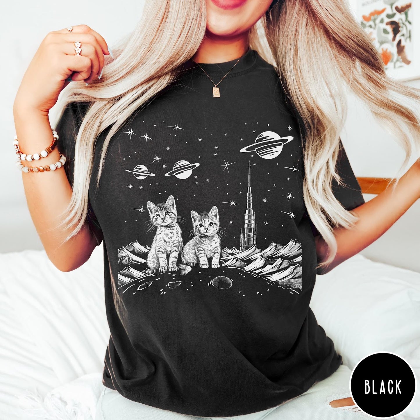 Comfort Colors tee in Black featuring line art graphic of two kittens sitting on a planet with rocket