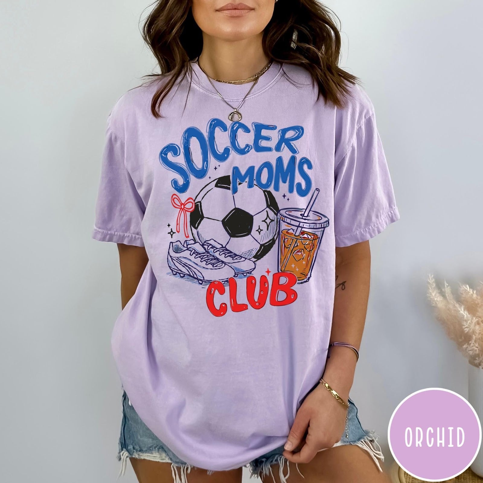 Comfort Colors tee in Orchid featuring soccer mom lifestyle graphic with soccer ball, cleats, and iced coffee