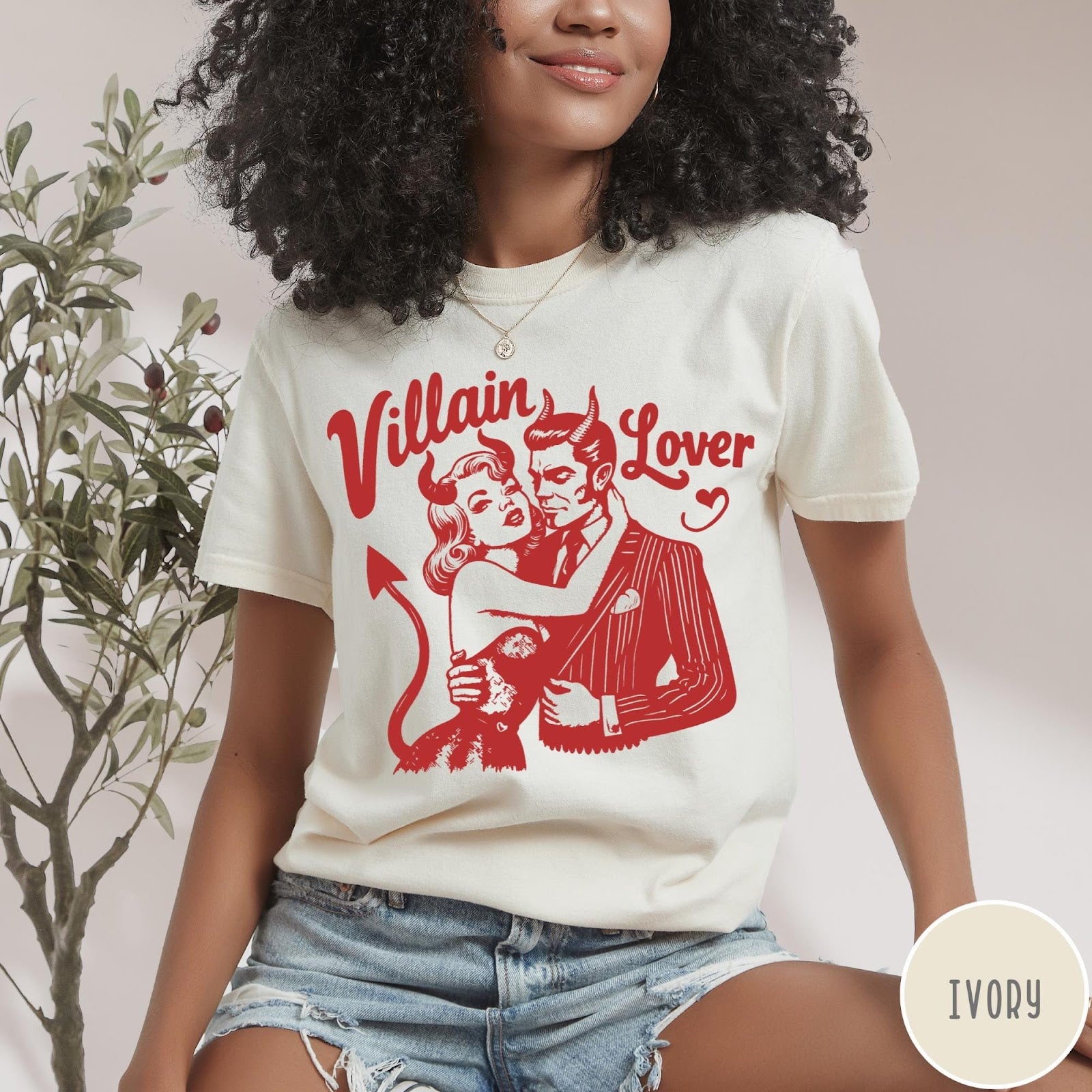 Comfort Colors tee in Ivory featuring vintage style graphic of a devilish couple embracing each other