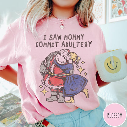 Comfort Colors tee in Blossom featuring vintage style graphic of Santa Claus kissing a woman under stars