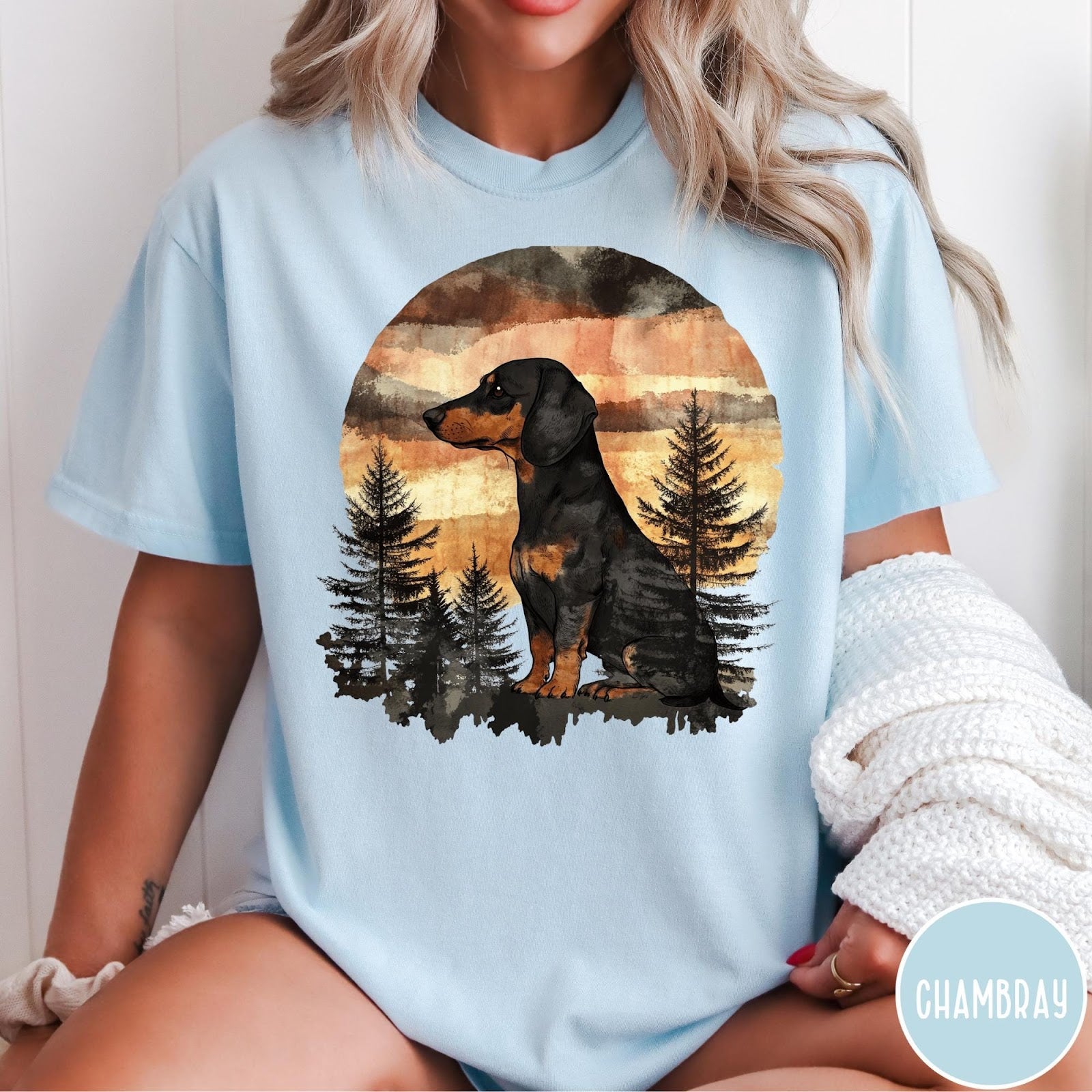 Comfort Colors tee in Chambray featuring vintage style graphic of a dachshund sitting in a forest sunset
