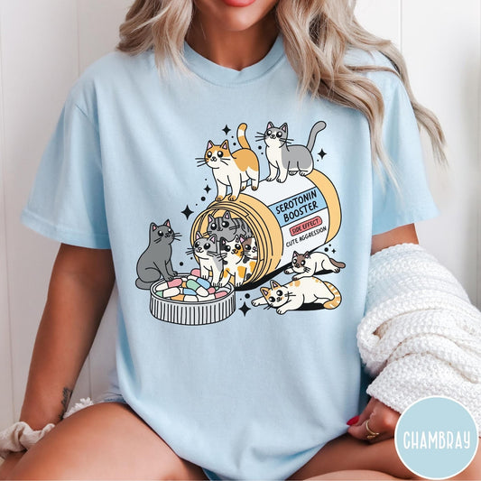 Comfort Colors tee in Chambray featuring graphic illustration of cats spilling out of a serotonin booster bottle