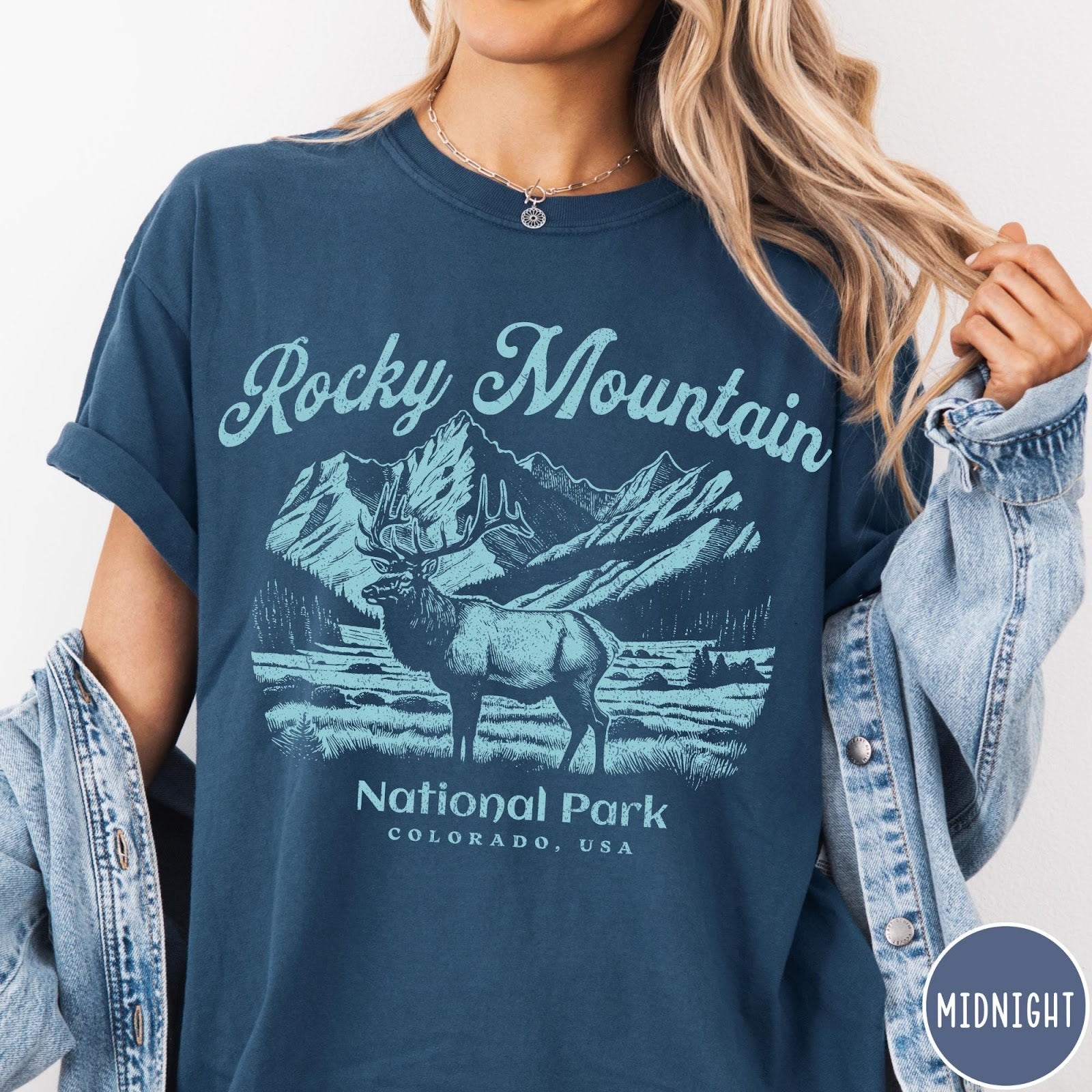 Comfort Colors tee in Midnight featuring vintage style graphic of an elk standing in front of mountains