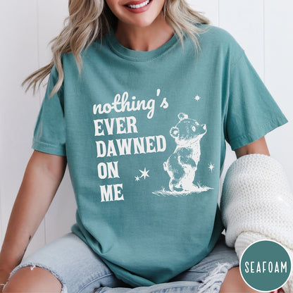 Comfort Colors tee in Seafoam featuring illustrated style graphic of a small bear looking up at stars