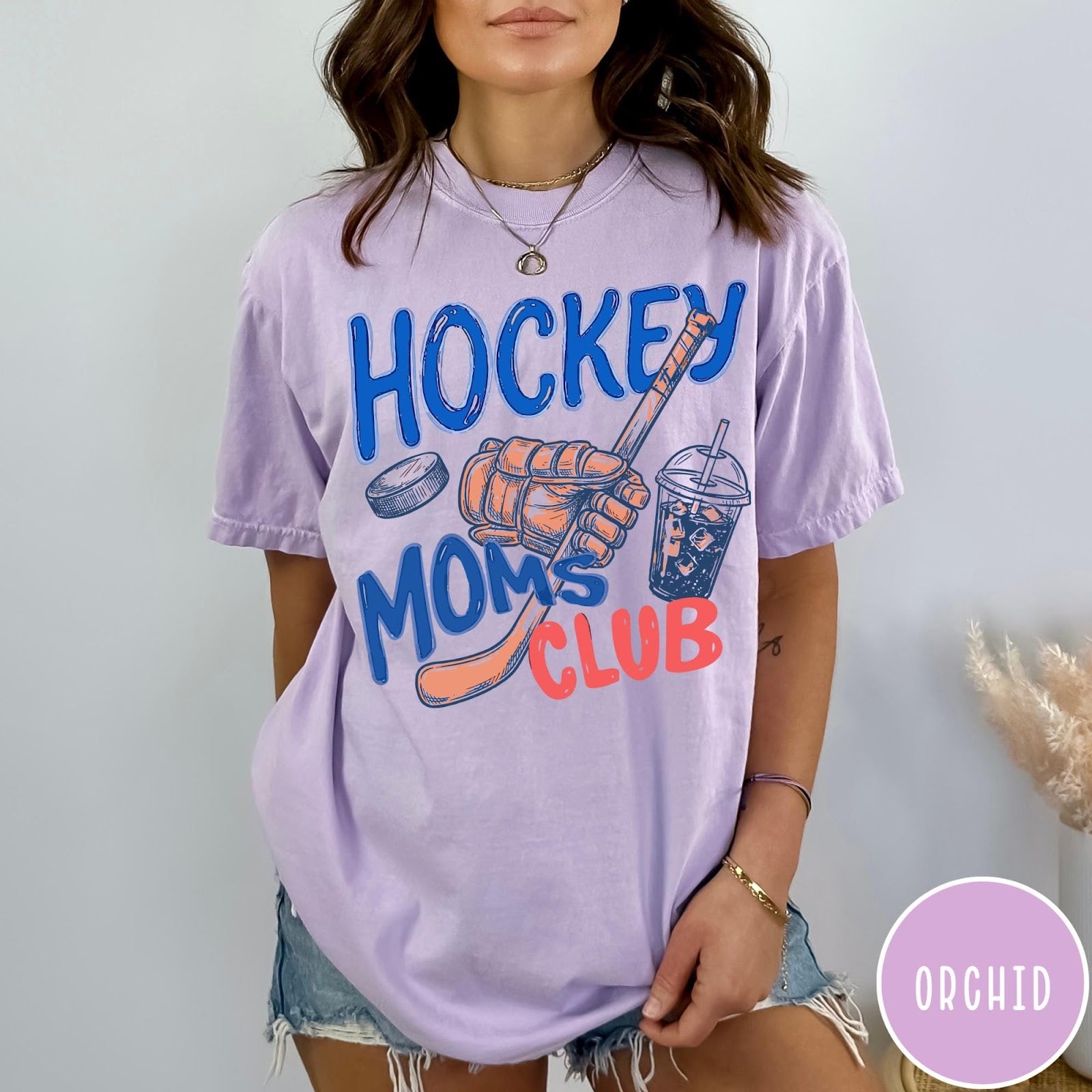Comfort Colors tee in Orchid featuring lifestyle graphic design with hockey glove, stick, puck, and iced coffee