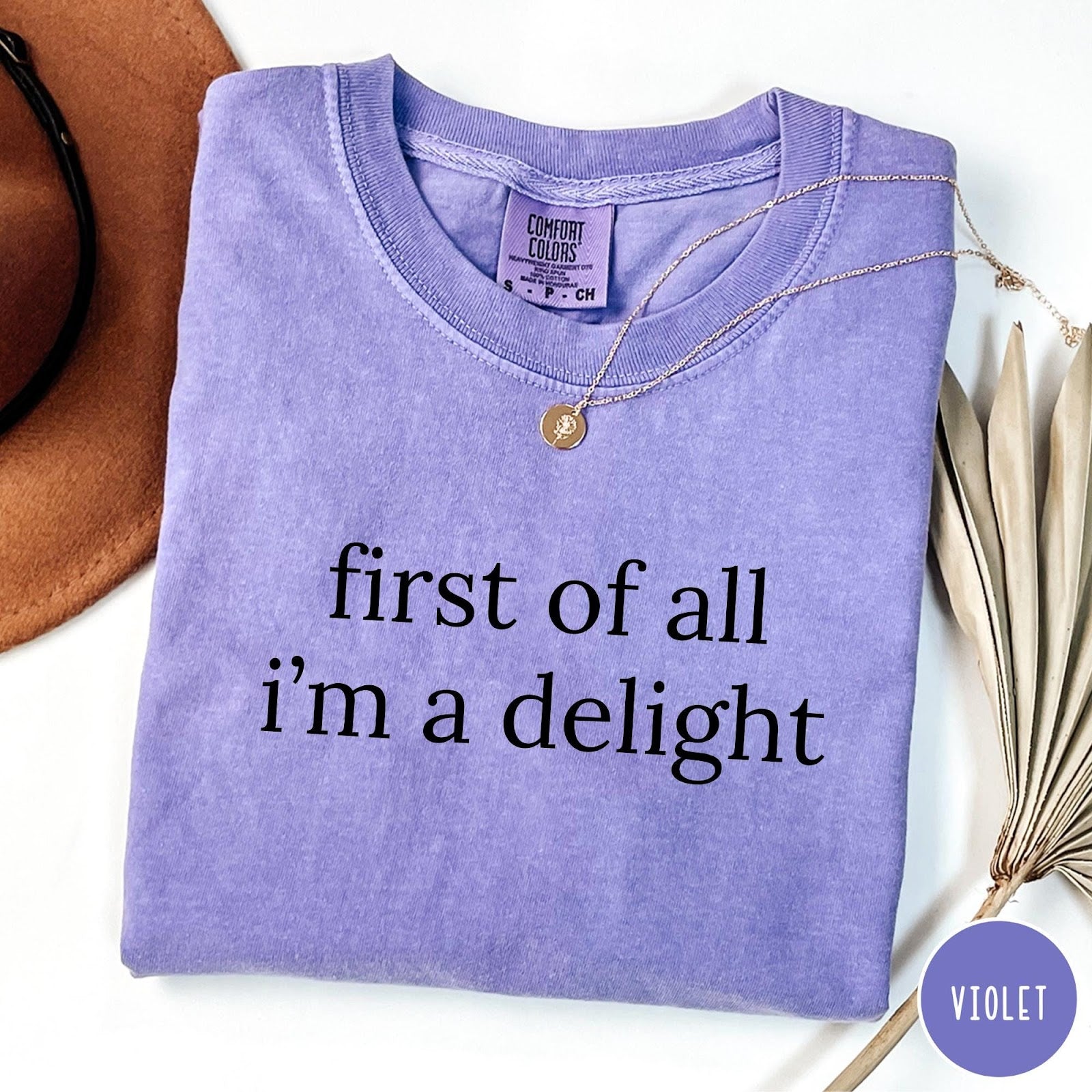 Comfort Colors tee in Violet featuring typography design with the text first of all i'm a delight
