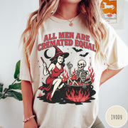 Comfort Colors tee in Ivory featuring witch and skeleton graphic with a boiling cauldron and spooky text