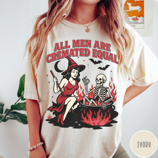 Comfort Colors tee in Ivory featuring witch and skeleton graphic with a boiling cauldron and spooky text