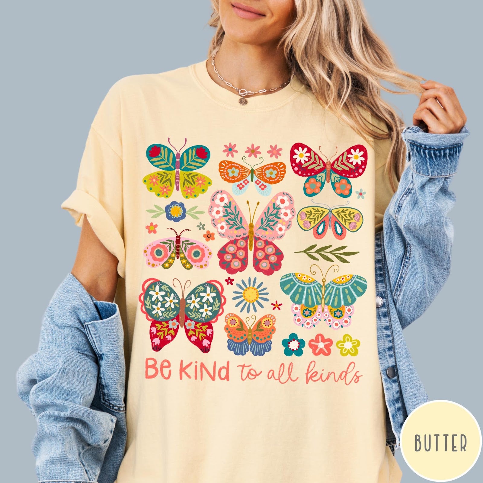 Comfort Colors tee in Butter featuring colorful butterfly and floral graphic with Be Kind to all kinds text