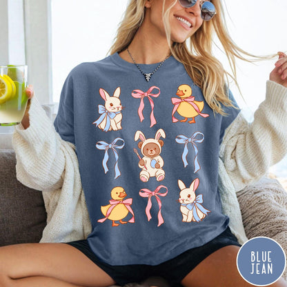 Comfort Colors tee in Blue Jean featuring vintage graphic style with Easter bunnies, ducks, and pink blue bows