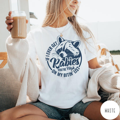 Comfort Colors tee in White featuring screen print style graphic of a raccoon with funny rabies text