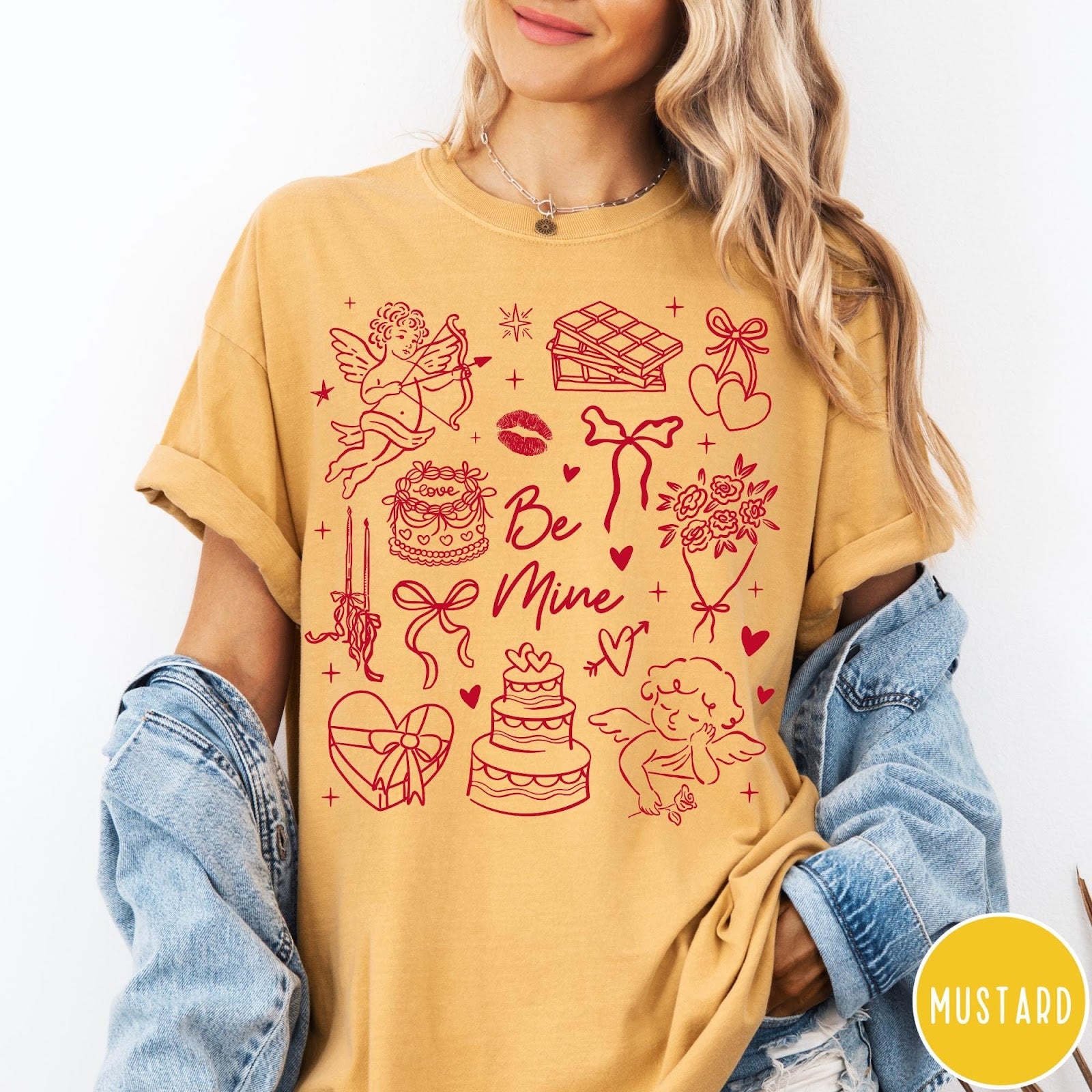 Comfort Colors tee in Mustard featuring Valentine's Day collage graphic with cupid, cakes, and romantic symbols.