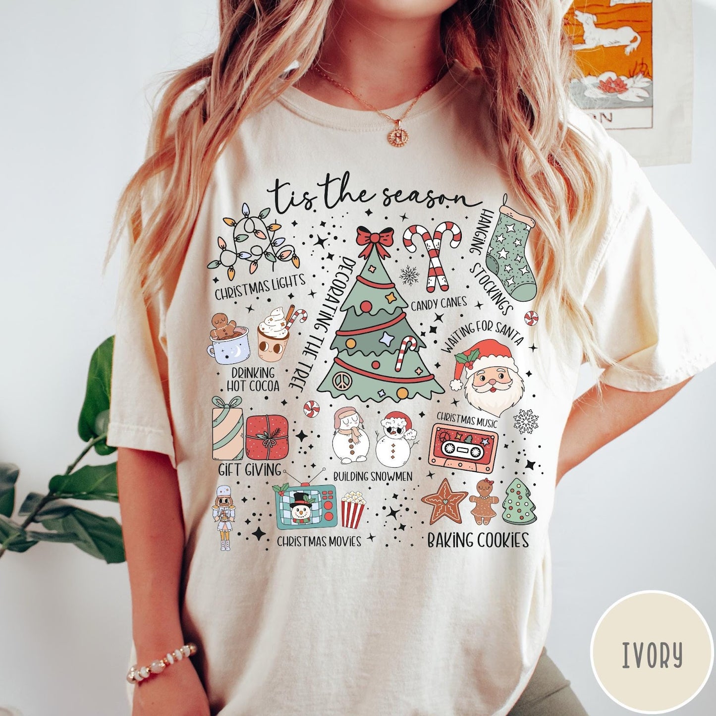 Comfort Colors tee in Ivory featuring festive holiday graphic with Christmas icons like a tree and cocoa