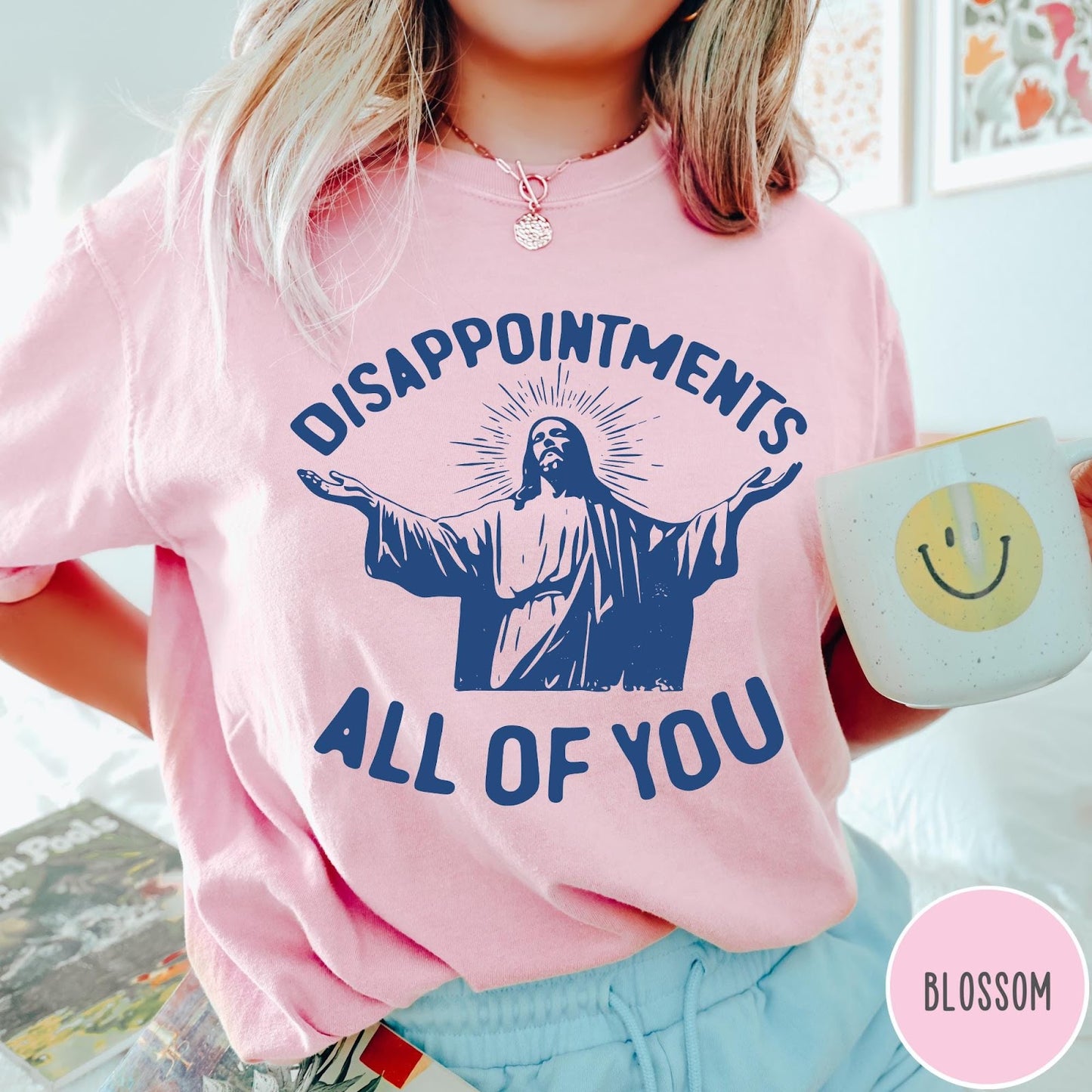 Comfort Colors tee in Blossom featuring screen print graphic of Jesus with arms outstretched and text Disappointments All Of You