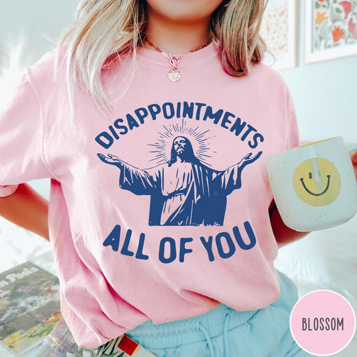 Comfort Colors tee in Blossom featuring screen print graphic of Jesus with arms outstretched and text Disappointments All Of You