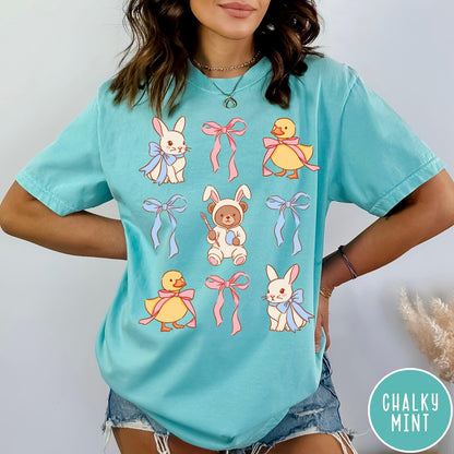 Comfort Colors tee in Chalky Mint featuring vintage style graphic with Easter bunnies, ducks, and pink blue bows