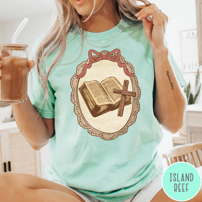 Comfort Colors tee in Island Reef featuring vintage style graphic of an open Bible and wooden Christian cross.