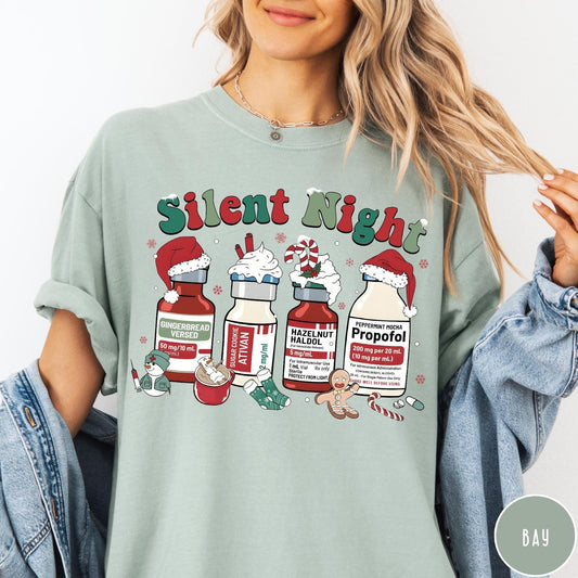 Comfort Colors tee in Bay featuring holiday graphic with medical vials styled as festive holiday treats