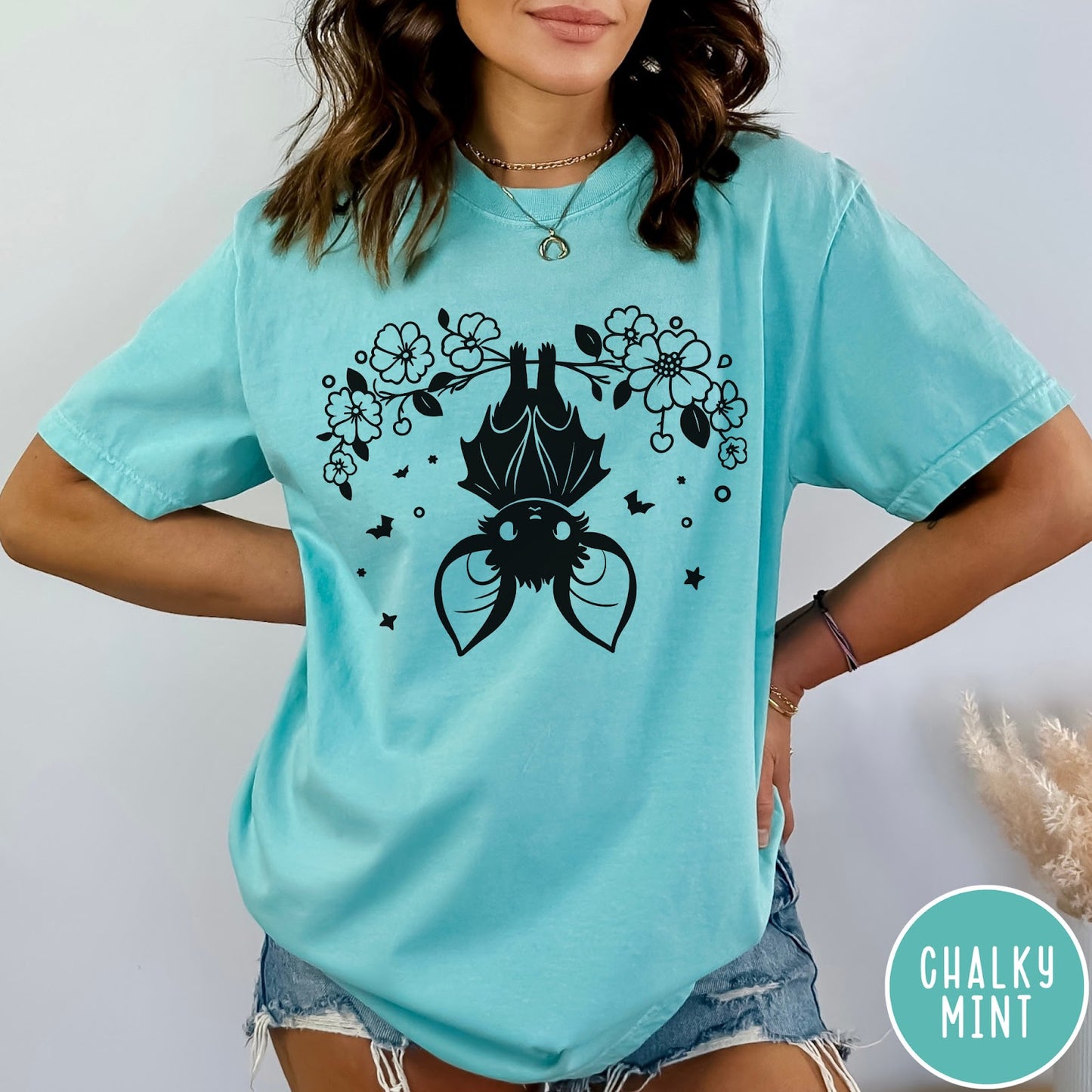 Comfort Colors tee in Chalky Mint featuring line art style upside down bat graphic with surrounding floral elements