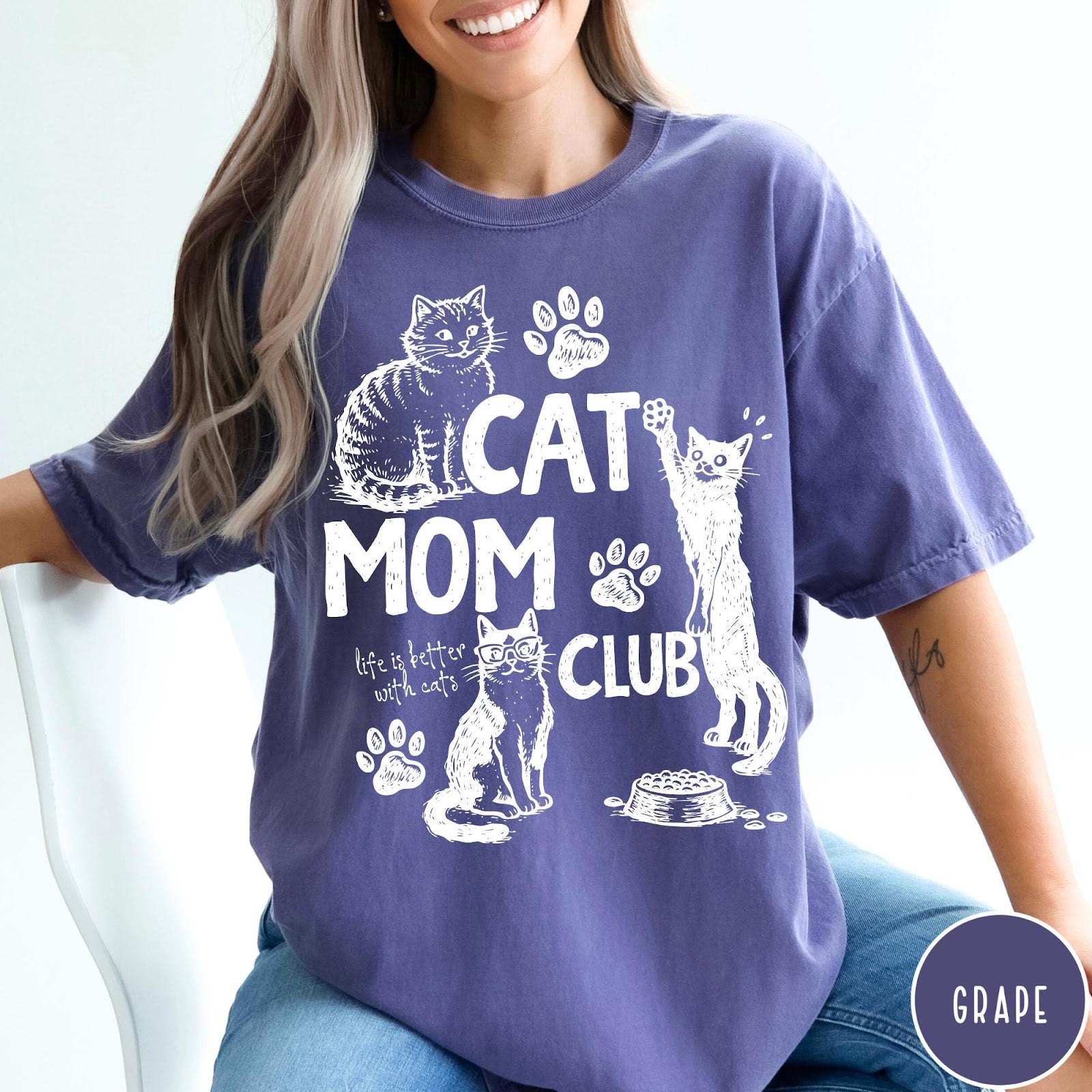 Comfort Colors tee in Grape featuring vintage style graphic with cats, paw prints, and Cat Mom Club text