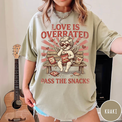 Comfort Colors tee in Khaki featuring vintage style graphic of a cherub eating snacks on a bench