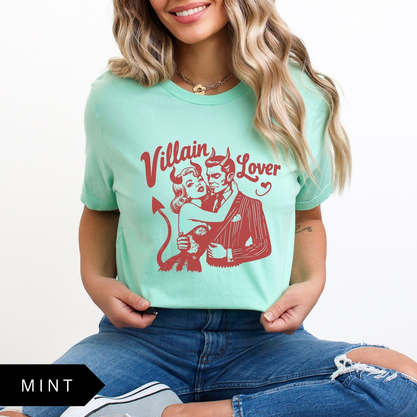 Comfort Colors tee in Mint featuring vintage style graphic of a devilish couple embracing with text Villain Lover