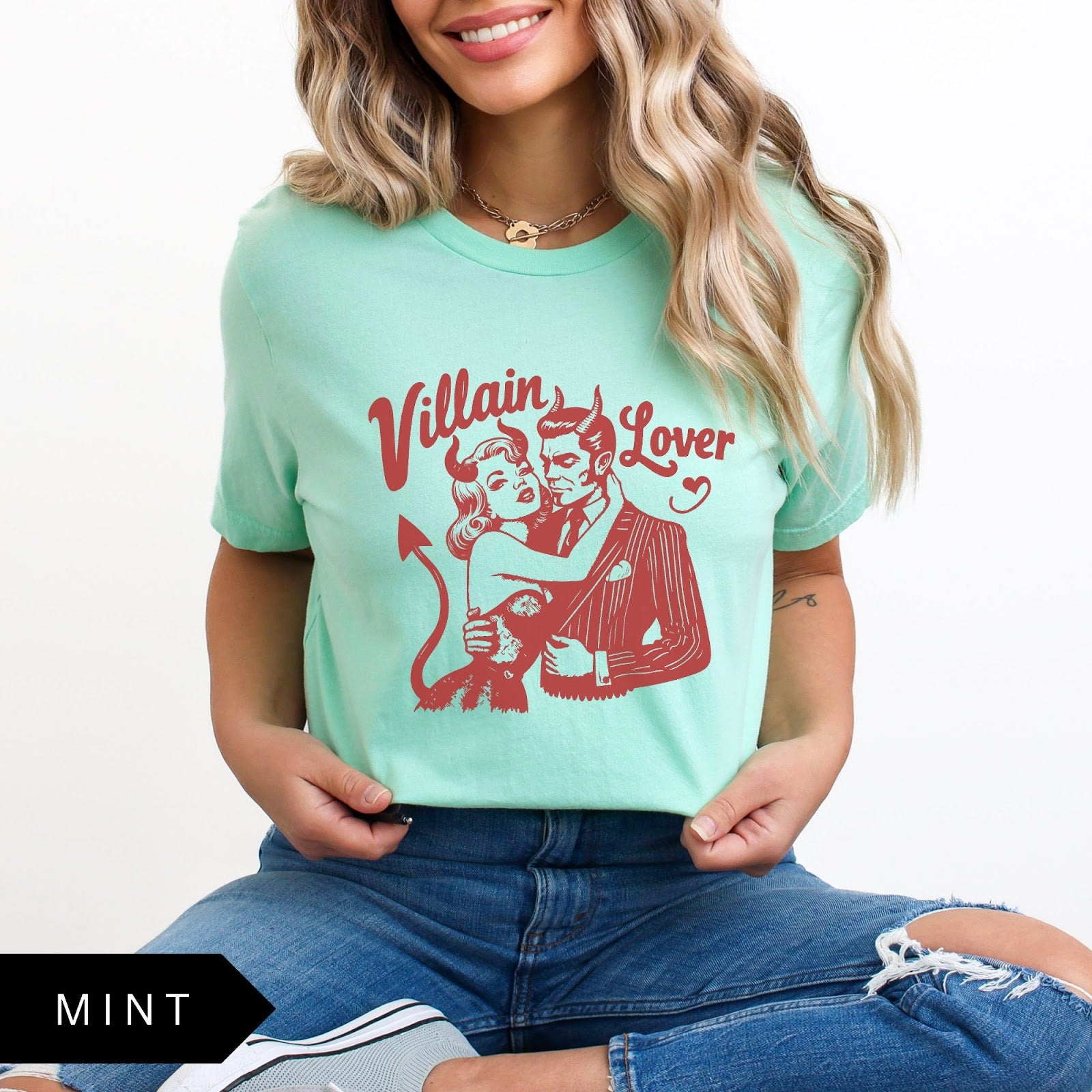 Comfort Colors tee in Mint featuring vintage style graphic of a devilish couple embracing with text Villain Lover