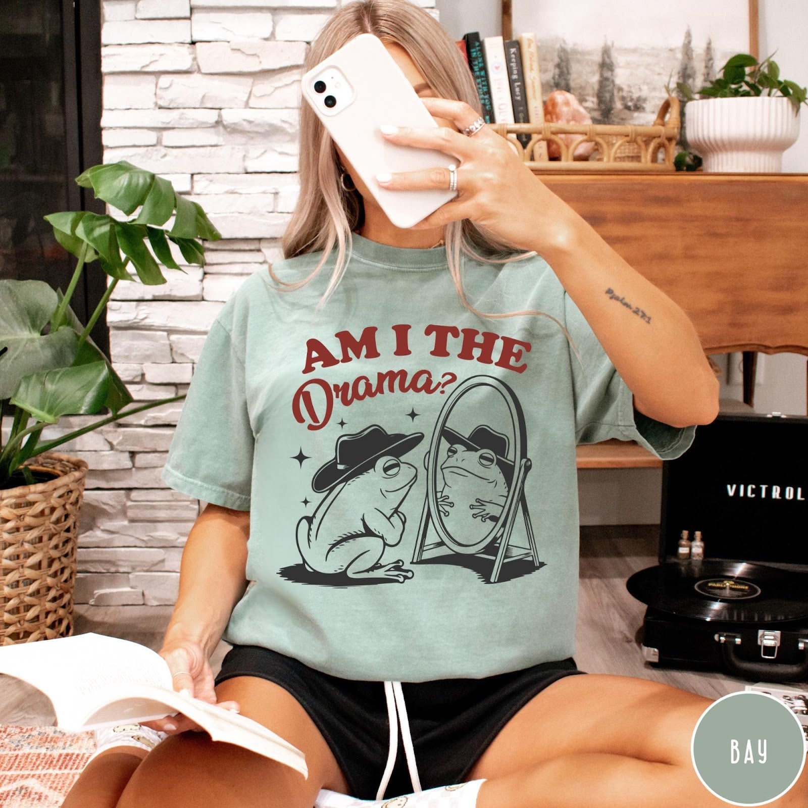 Comfort Colors tee in Bay featuring whimsical frog graphic with a cowboy hat looking into a mirror
