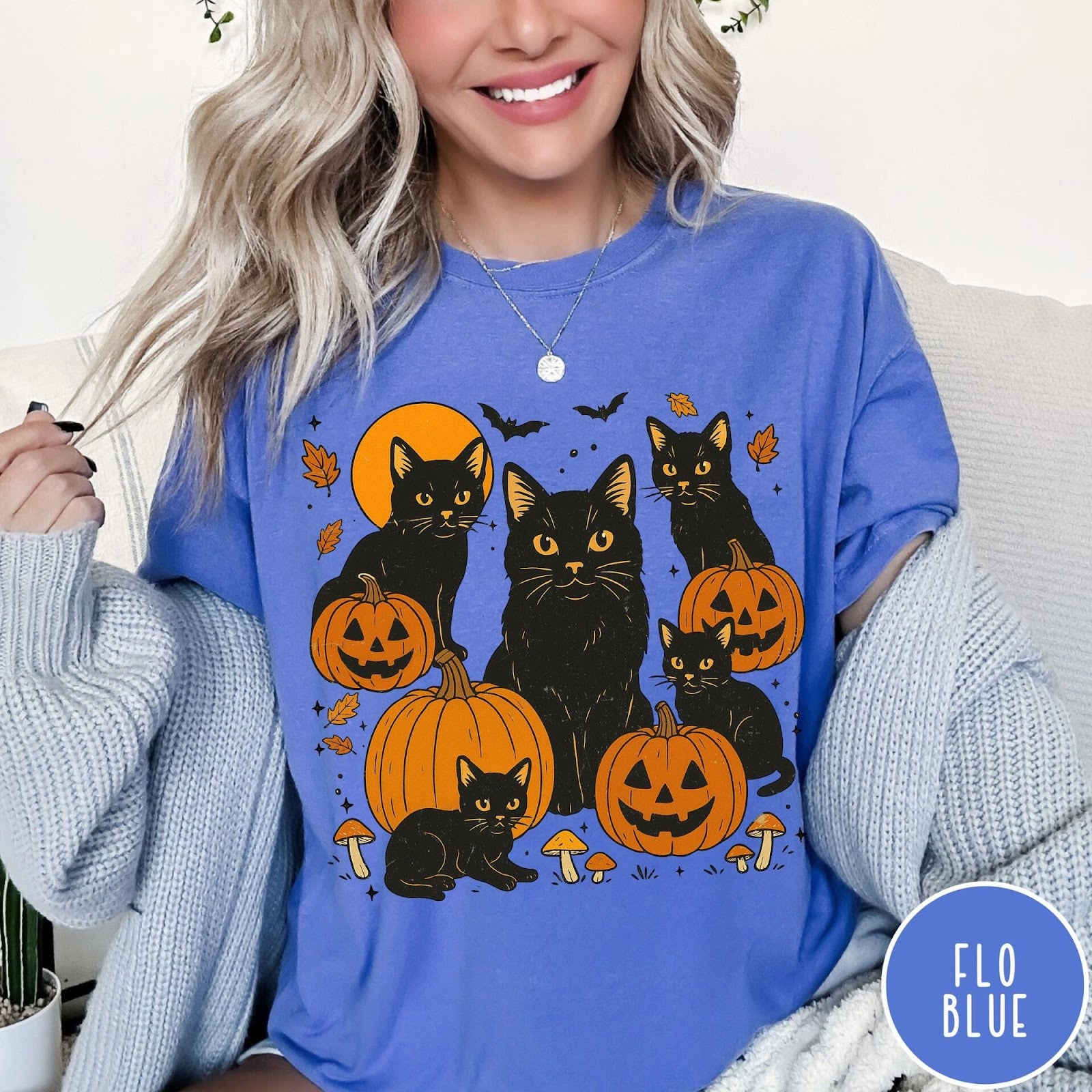 Comfort Colors tee in Flo Blue featuring Halloween style graphic with black cats, pumpkins, bats, and fall leaves