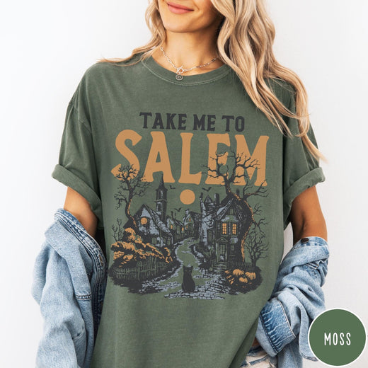Comfort Colors tee in Moss featuring vintage style Salem town scene with black cat and pumpkins