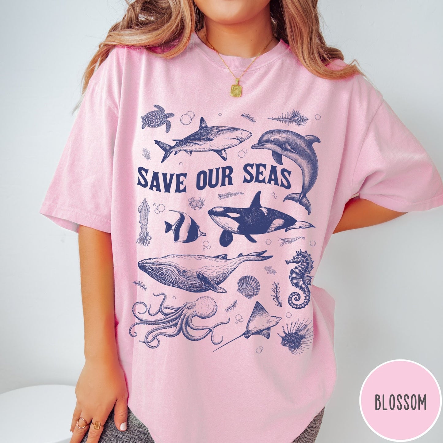 Comfort Colors tee in Blossom featuring marine life graphic design with various sea creatures and Save Our Seas text