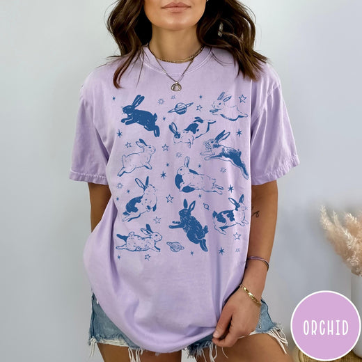 Comfort Colors tee in Orchid featuring celestial design style with jumping bunnies and planets graphic print