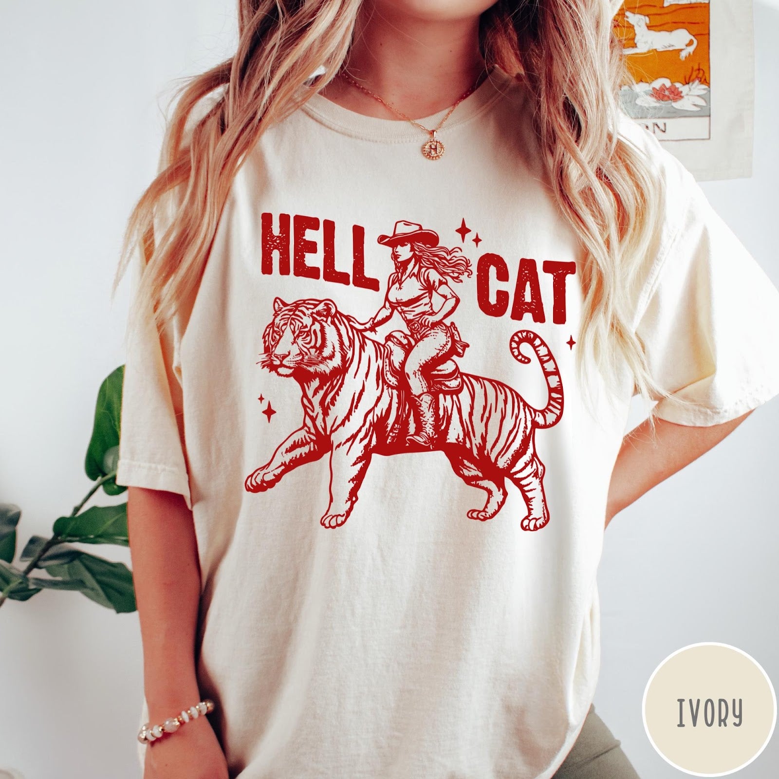 Comfort Colors tee in Ivory featuring western style graphic of a cowgirl riding a tiger