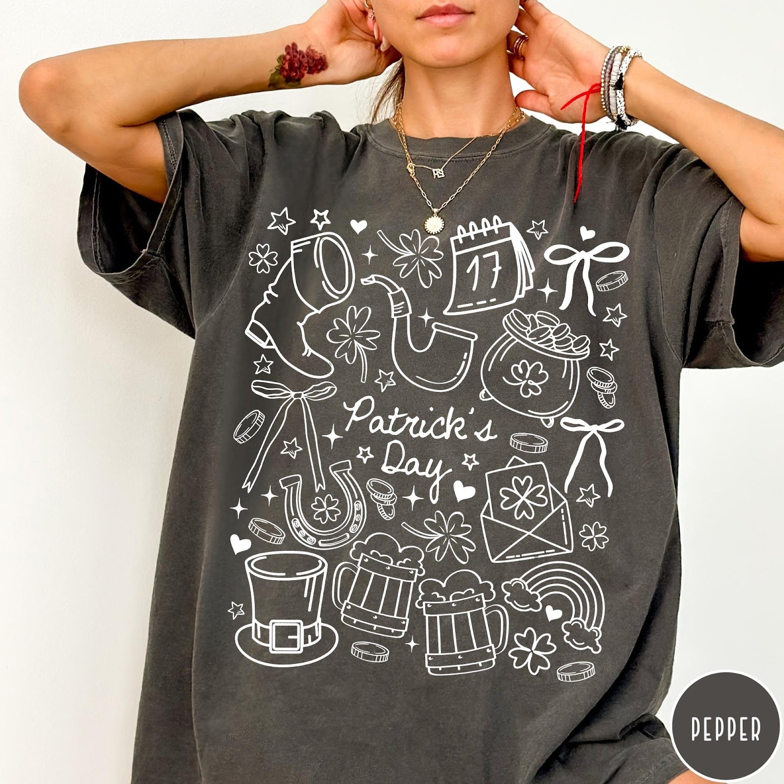 Comfort Colors tee in Pepper featuring line art style St. Patrick's Day icons and symbols