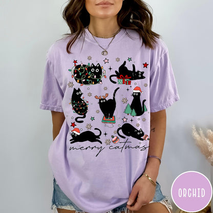 Comfort Colors tee in Orchid featuring festive holiday graphic with multiple black cats and Christmas elements
