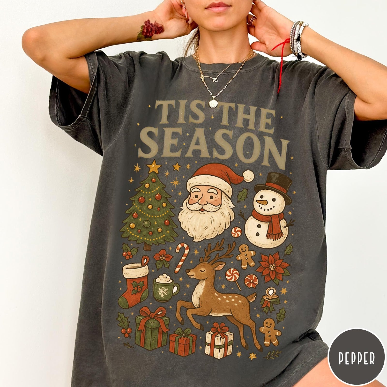 Comfort Colors tee in Pepper featuring Christmas collage graphic with Santa, snowman, reindeer, and holiday gifts