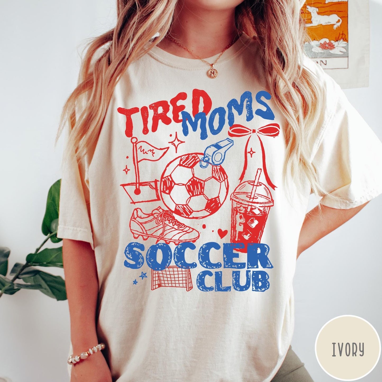 Comfort Colors tee in Ivory featuring soccer mom life graphic with soccer ball, whistle, and iced coffee