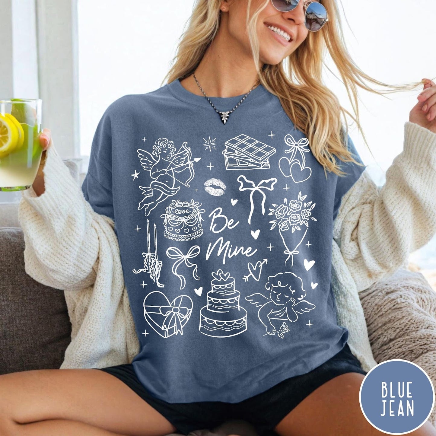 Comfort Colors tee in Blue Jean featuring Valentine's Day collage graphic with cupid, cakes, and romantic symbols.