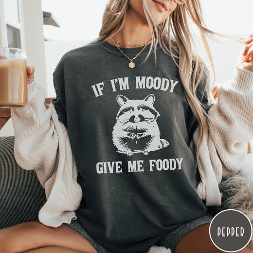 Comfort Colors tee in Pepper featuring vintage style graphic of a raccoon with text If I'm Moody Give Me Foody
