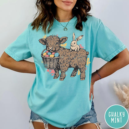 Comfort Colors tee in Chalky Mint featuring graphic style Highland cow and bunny with an Easter egg basket