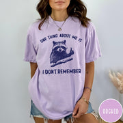Comfort Colors tee in Orchid featuring screen print style graphic of a raccoon giving a thumbs up