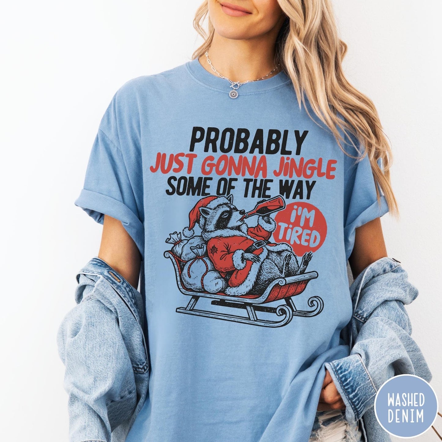 Comfort Colors tee in Washed Denim featuring festive raccoon graphic in a sleigh with holiday text design